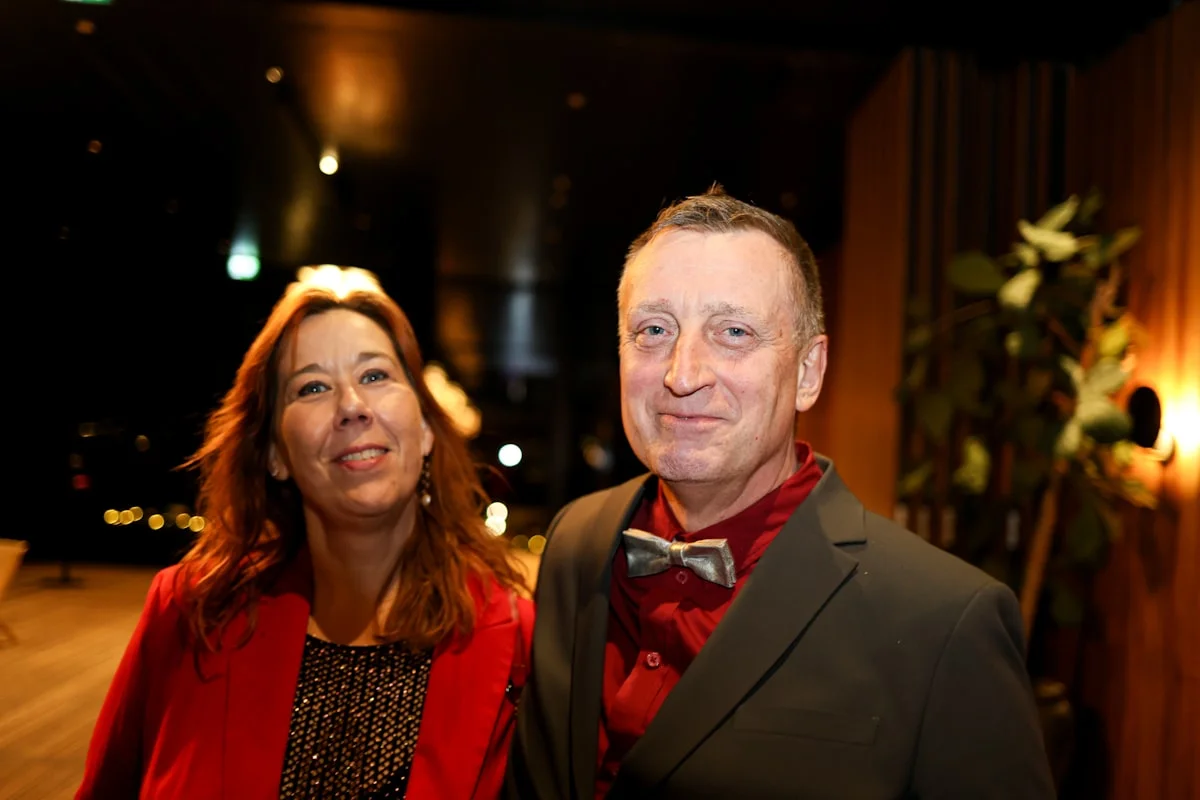 Guests dressed formally at a black tie optional evening event