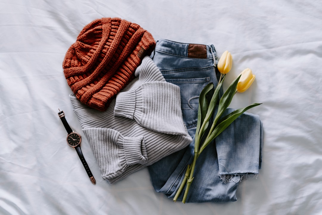 Capsule wardrobe clothing pieces laid out flat for outfit planning